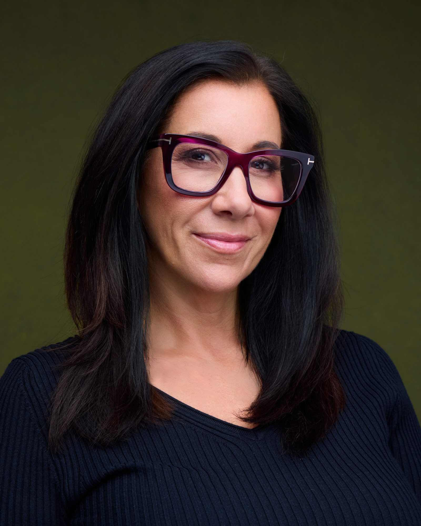 Suzanne Covert, Austin headshot photographer, reviewing portraits during a session