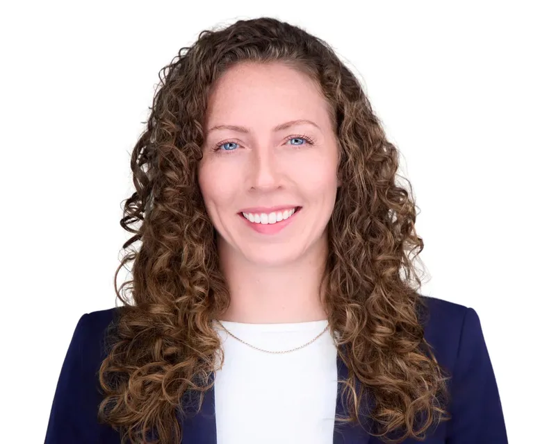 Approachable real estate headshot of a smiling woman on a white backdrop