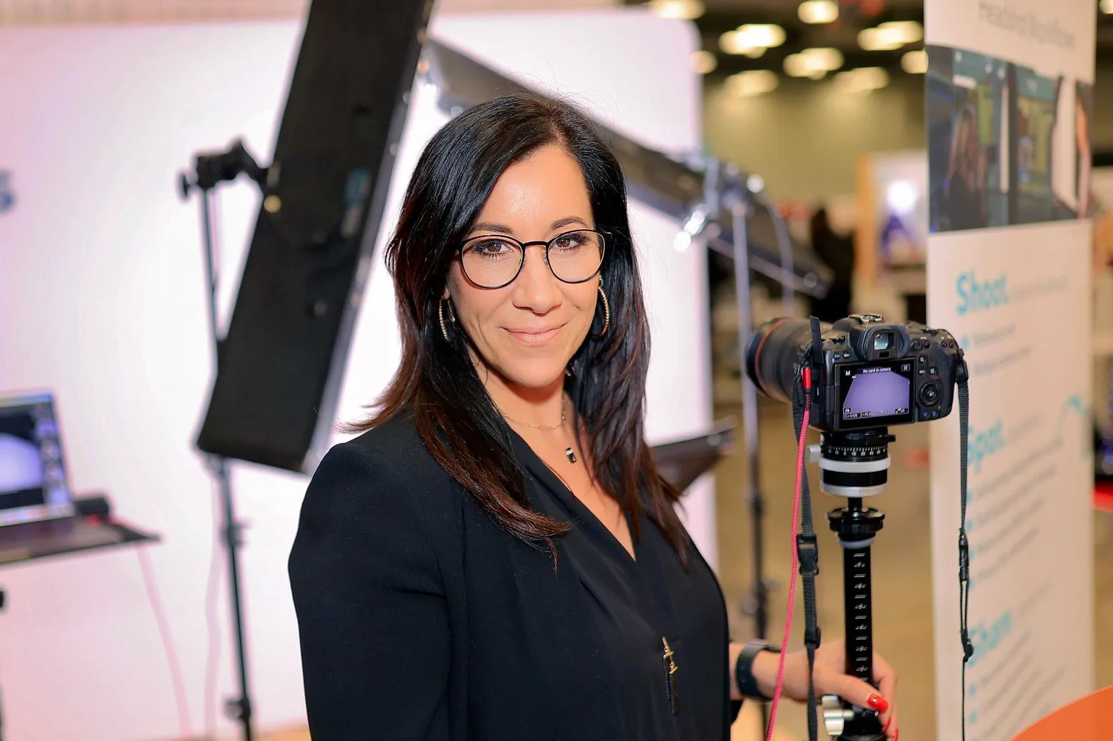Suzanne Covert at her conference headshot booth with studio lighting